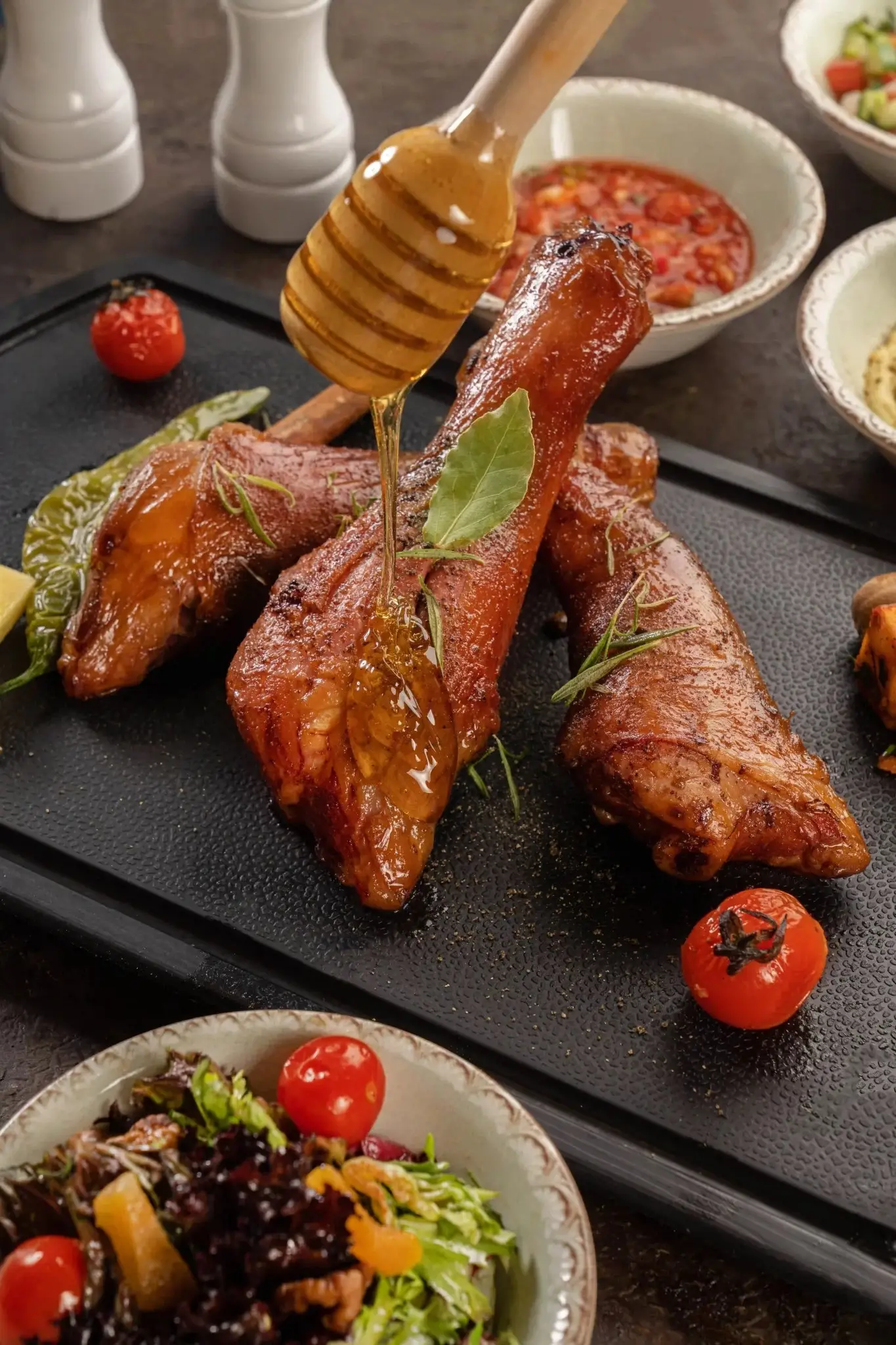 Smoked halal lamb being finished with a drizzle of honey at the table